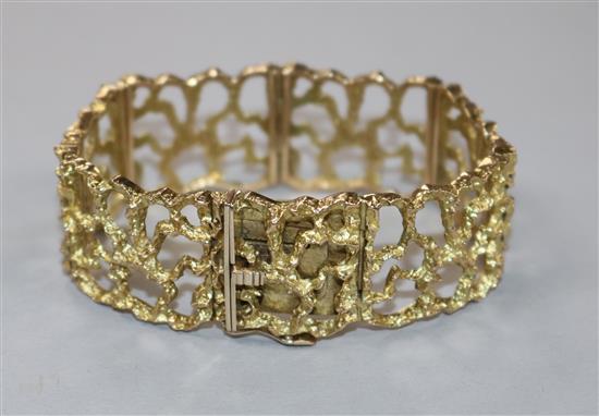 An early 1970s pierced 9ct textured gold bracelet.